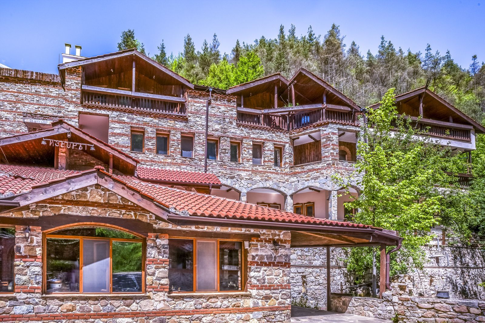 The stone façade of the hotel in summer