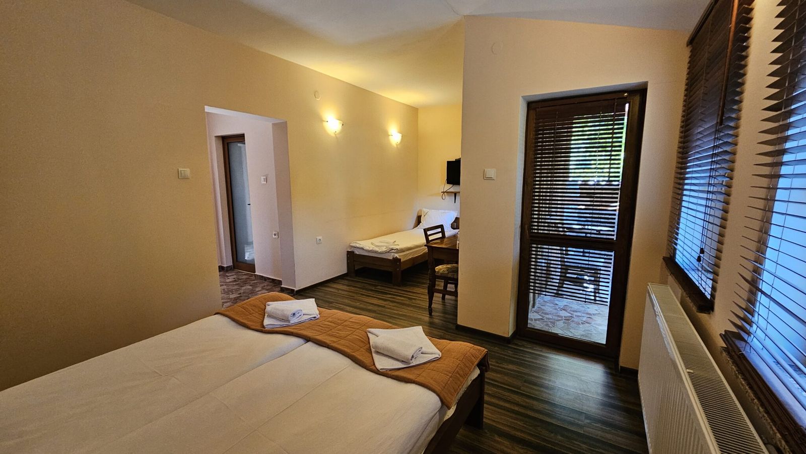 A double room with a large bed and a mountain window