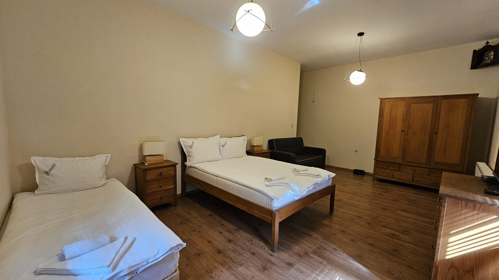 The single and double beds, with a wardrobe in the corner