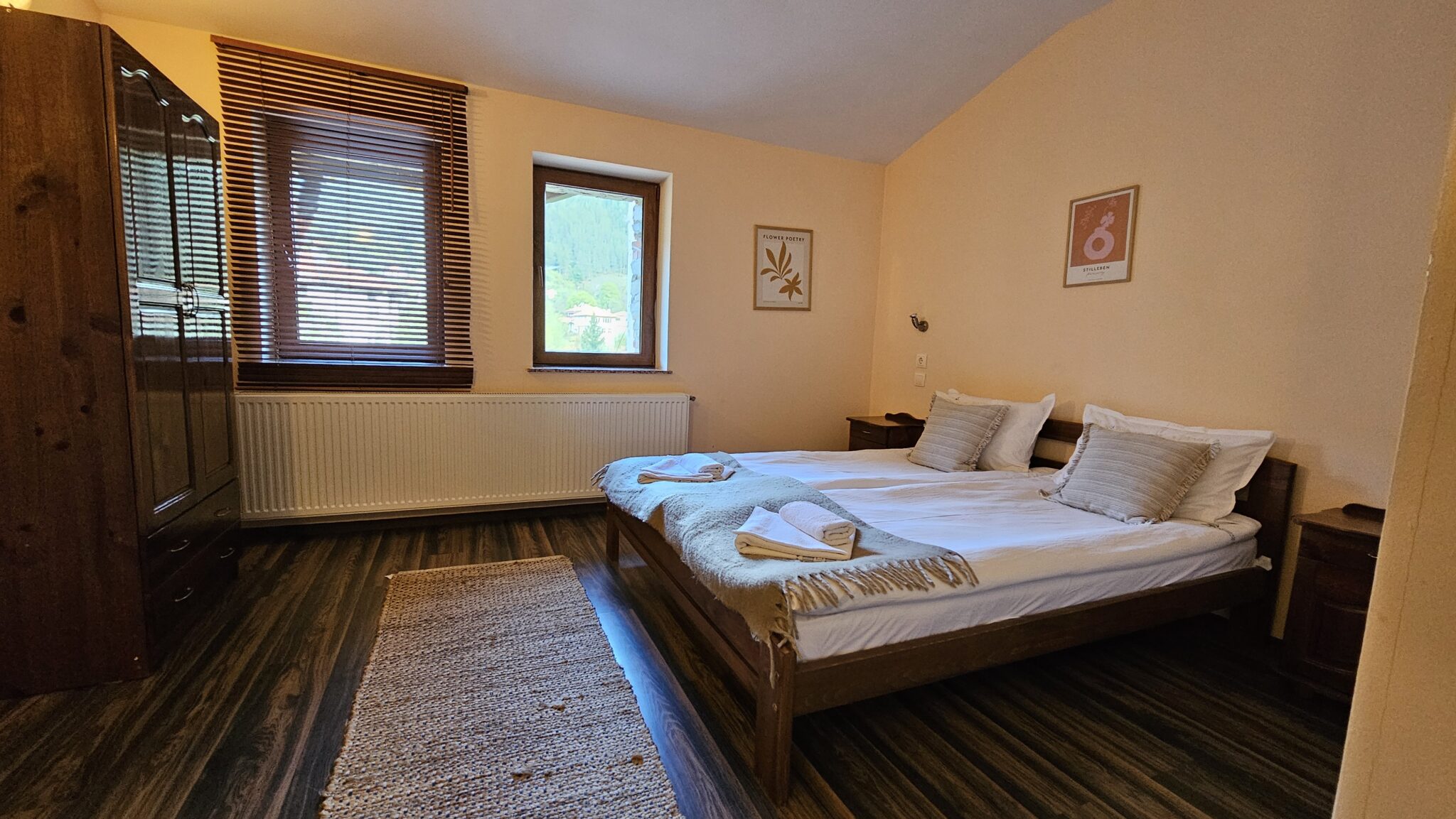 The double bed with a rug in front of it