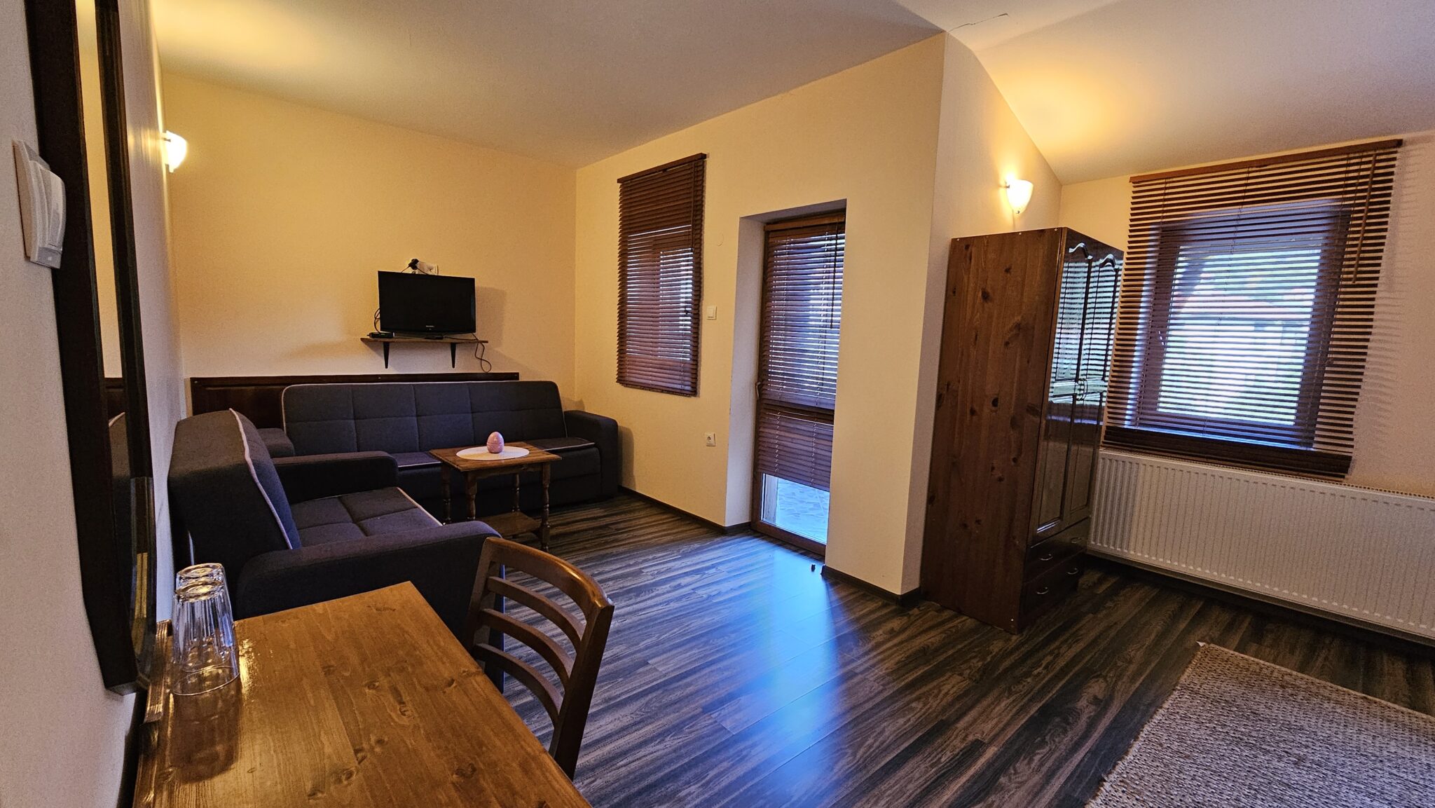 The seating corner with sofa, dining table and television
