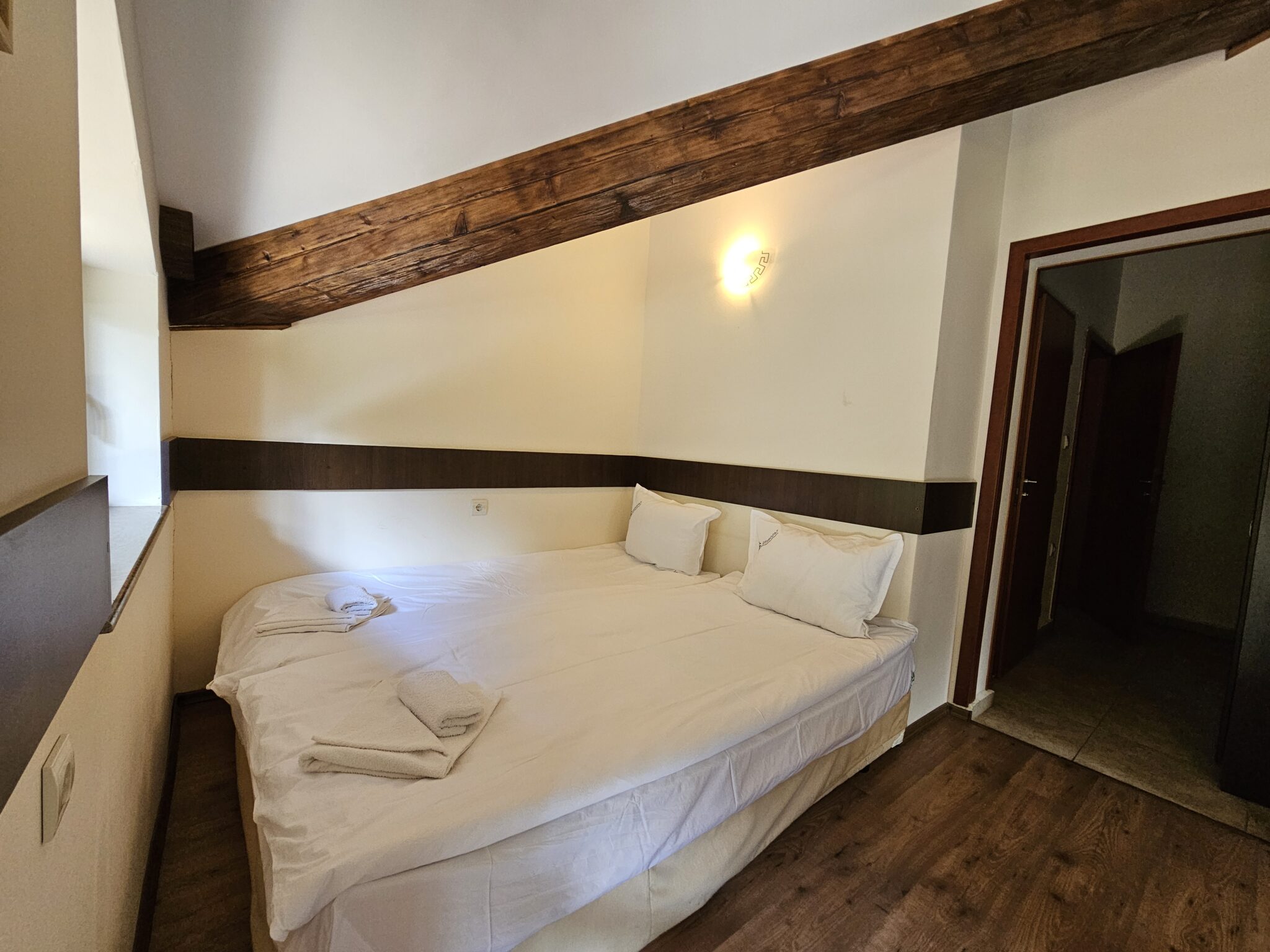 The double bed and the bathroom door