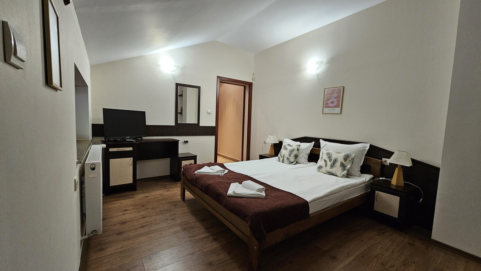 Television and chest of drawers facing the bed