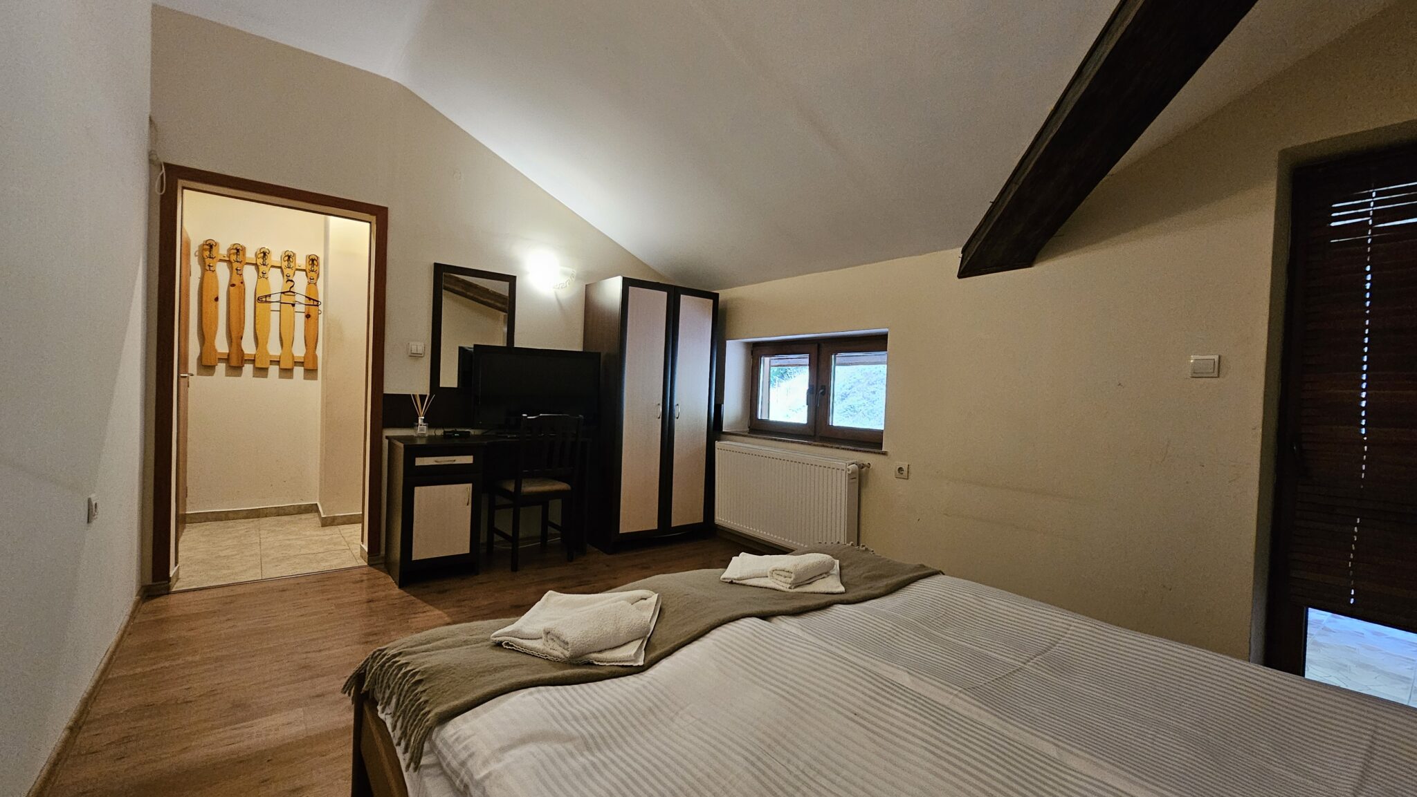 Dressing table with mirror and wardrobe facing the bed