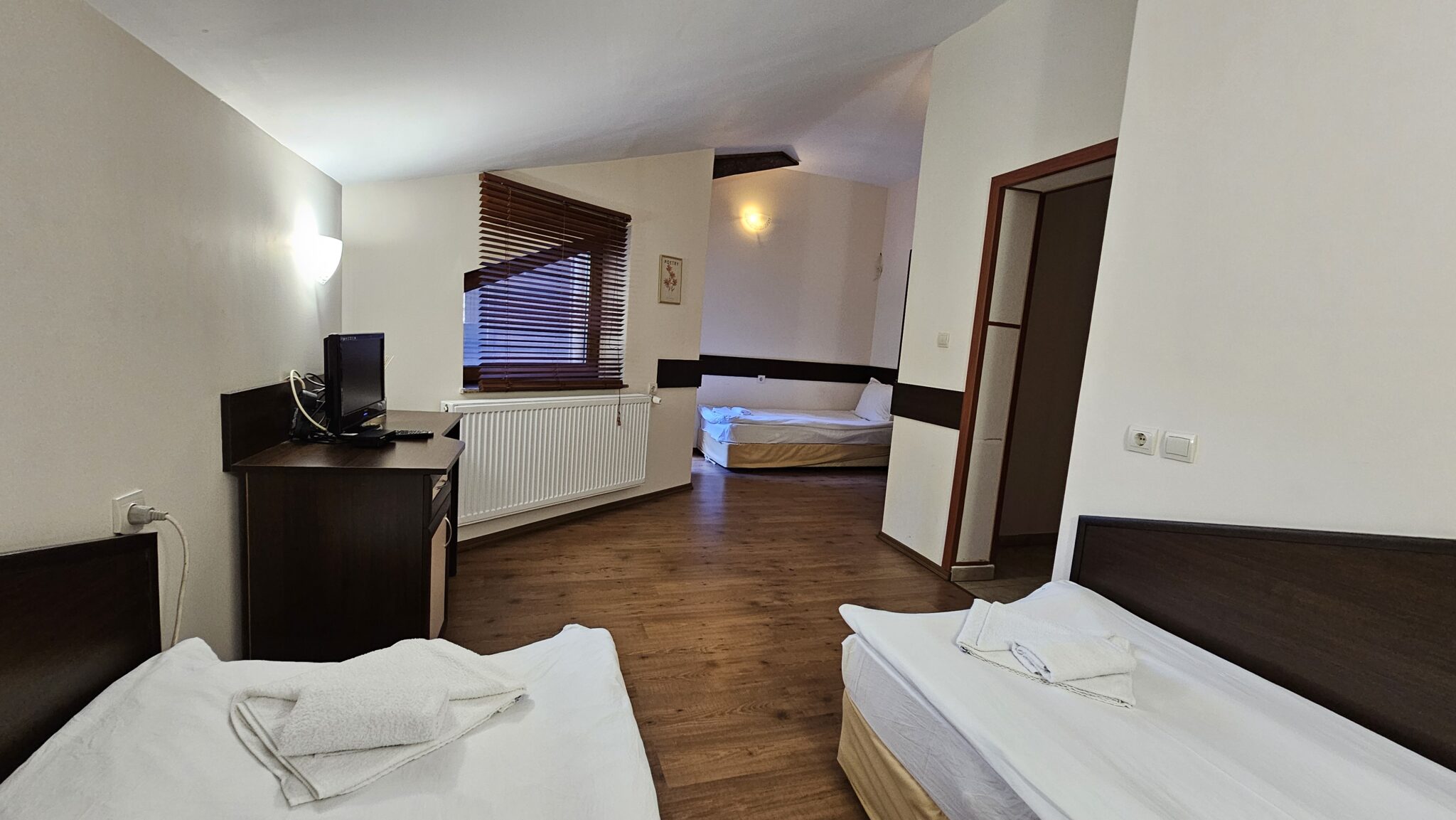 The third bed and the chest of drawers, looking across the room