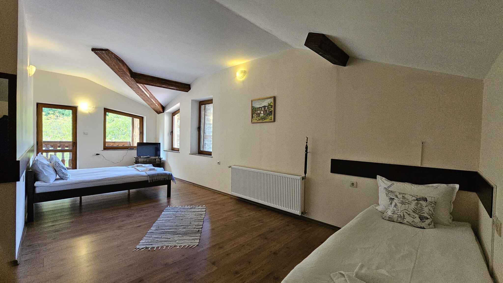 The double and single beds, with a picture on the wall