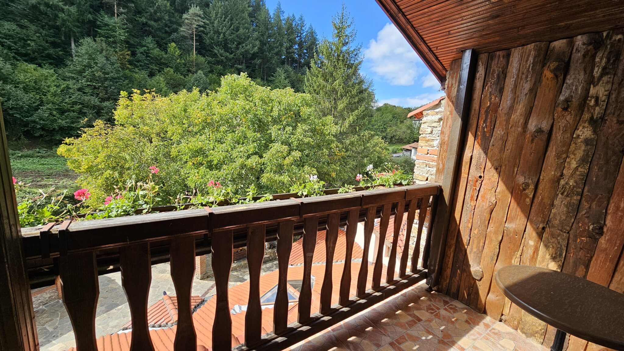 The balcony with wooden railings and flowers