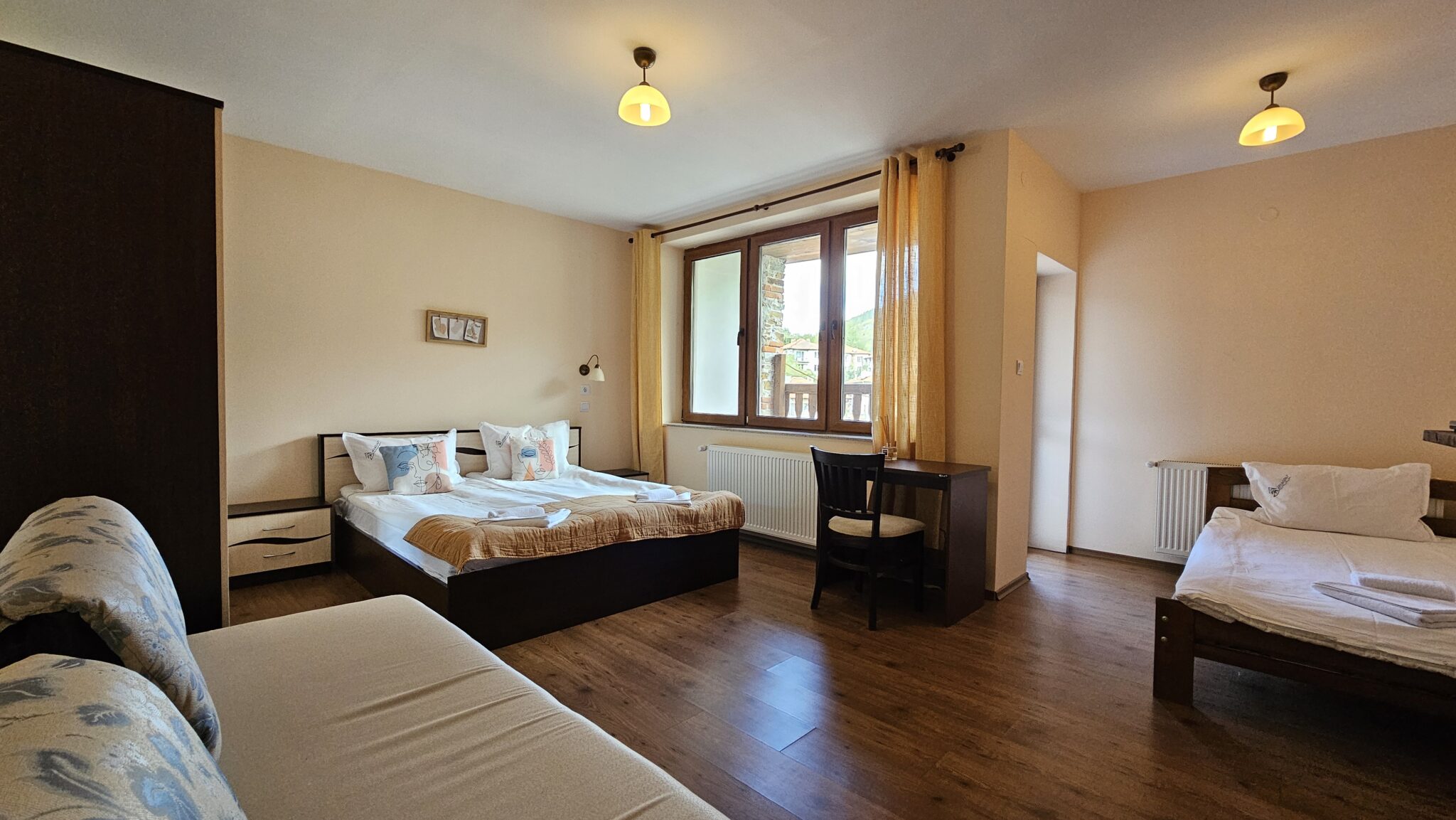 The bed and the yellow curtains at the window