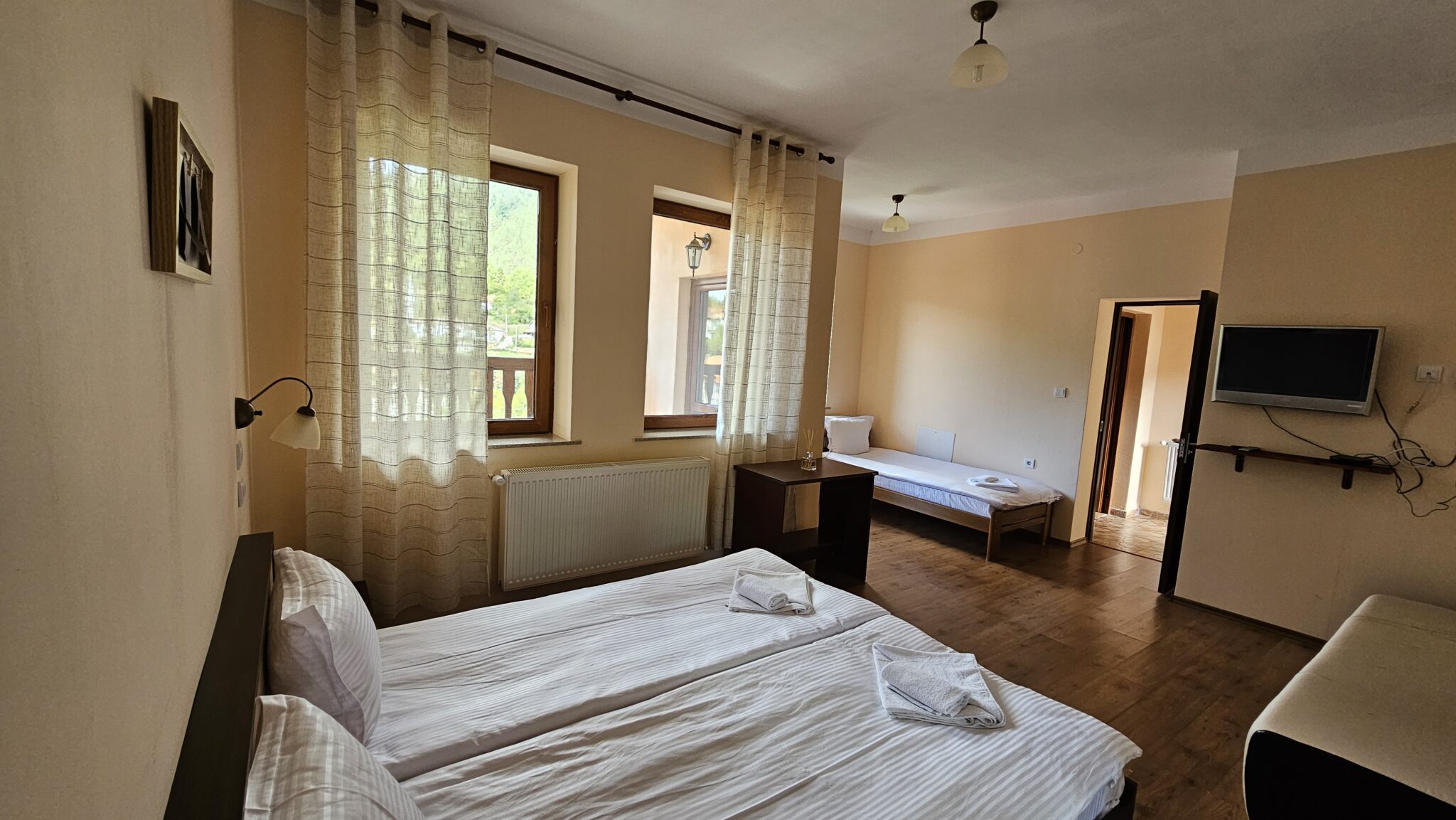 The double bed, with the single one by the window